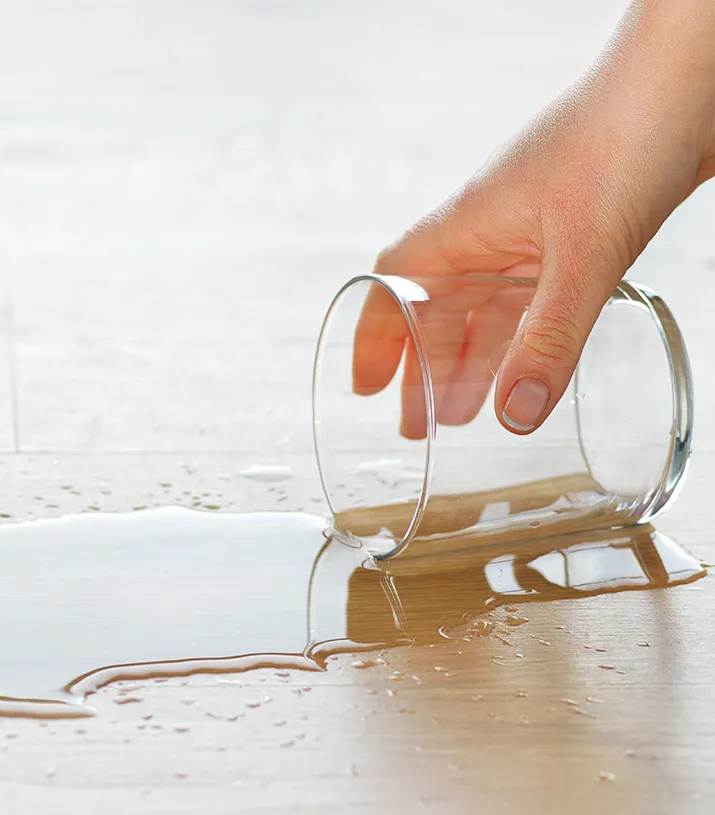 A spilled glass of water on laminate flooring | Floortrends