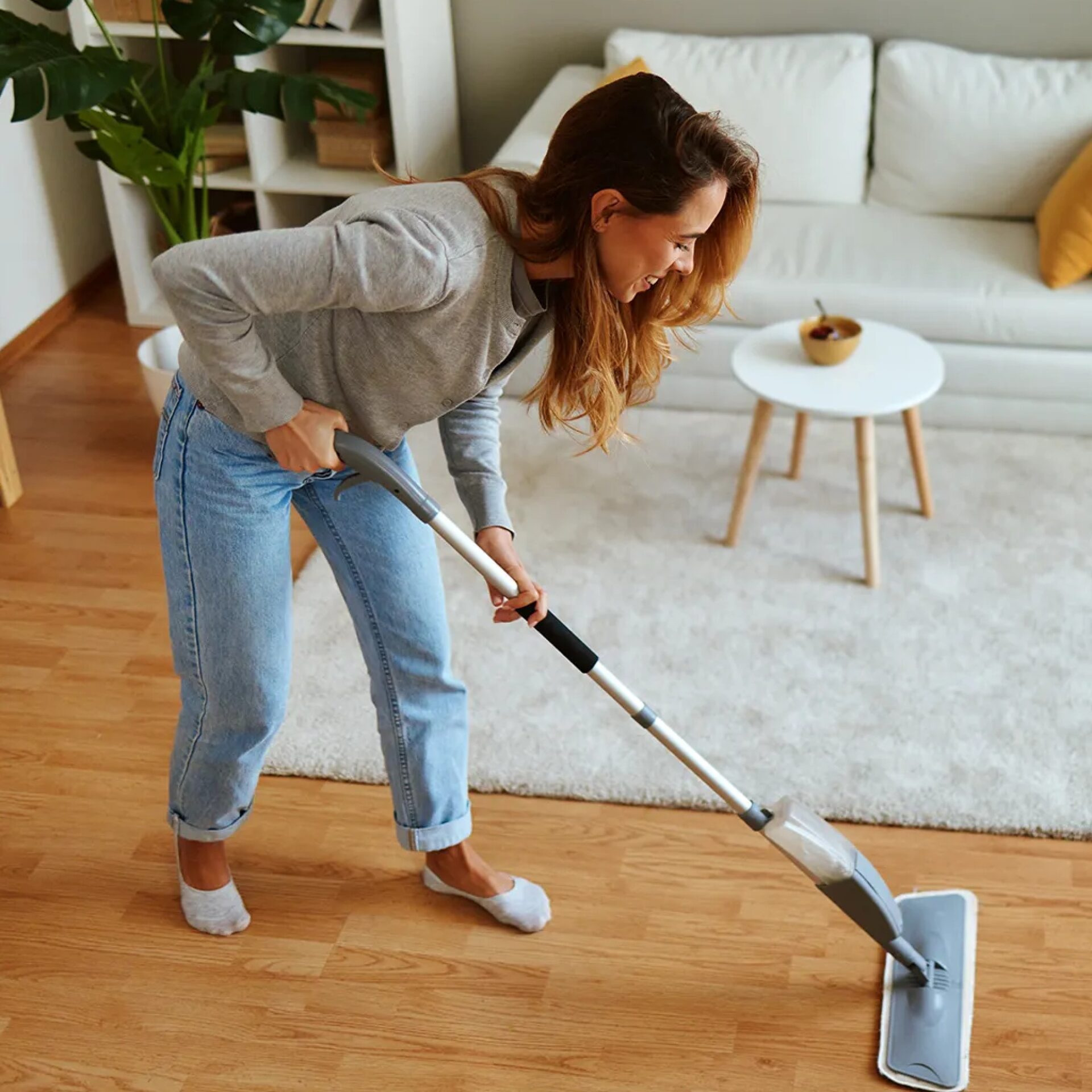 Woman cleaning hardwood flooring