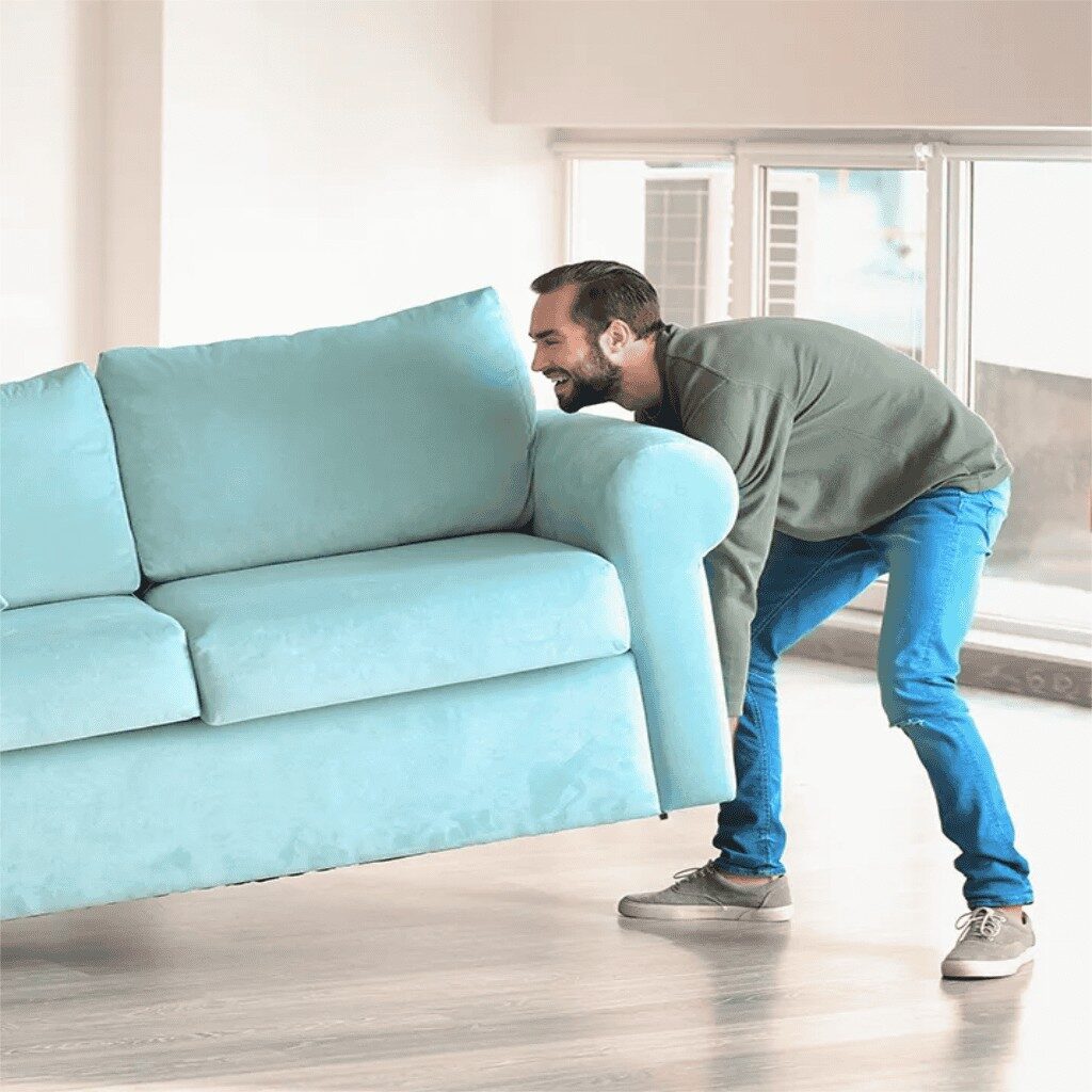 Man lifting a blue sofa